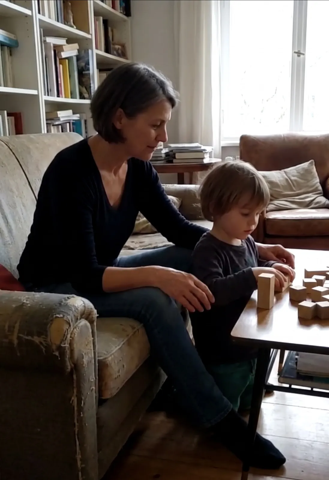 Maren building blocks with her grandson on the couch